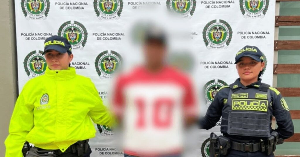 Agresor sexual del humedal Juan Amarillo: el capturado, con el rostro difuminado, custodiado por dos agentes de la Policía Nacional de Colombia