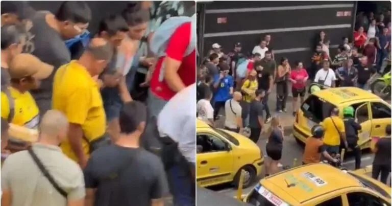 Asesinato en centro comercial de Bucaramanga: multitud reunida a la salida de San Andresito La Isla tras el ataque, con taxis amarillos en la calle