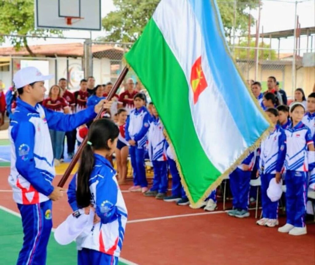 Atletas juveniles en una de las canchas deportivas Barinas rehabilitadas, junto a la bandera del estado
