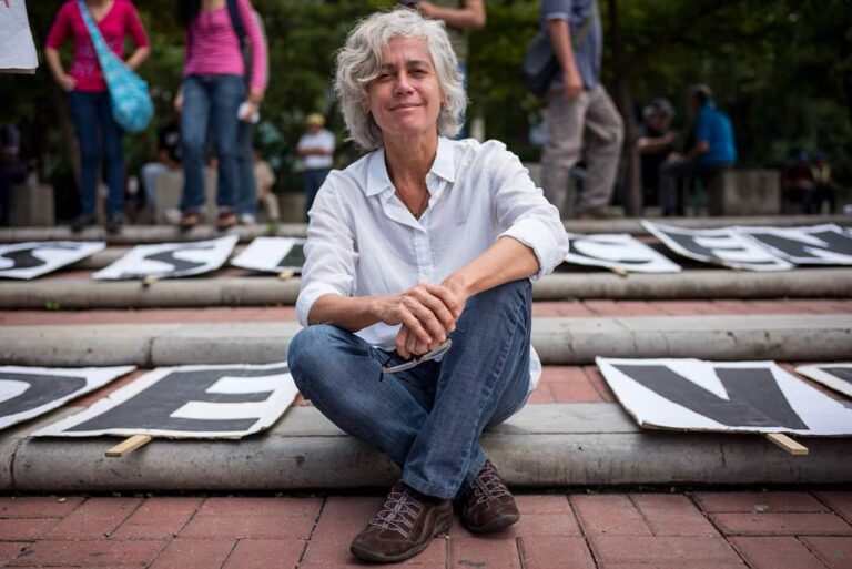 Mariela Ramírez sentada entre las letras de Dale Letra durante una jornada cívica en Caracas